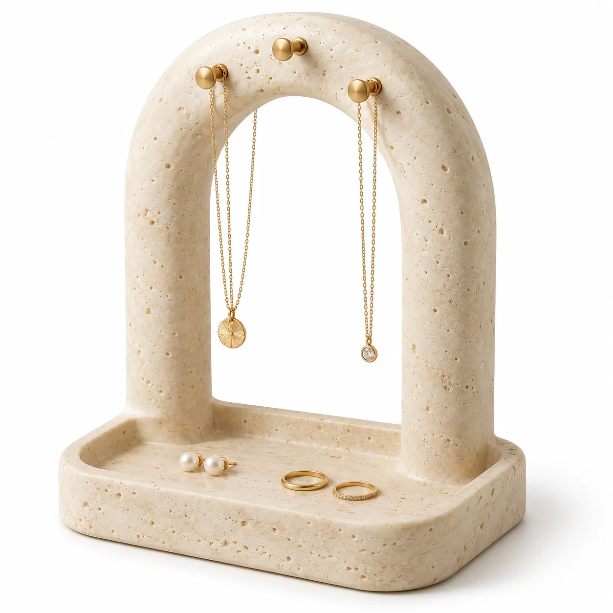 KELIKULI Stone Arch sculptural resin jewelry organizer with three gold-tone pegs and integrated vanity tray, styled with necklaces, pearl earrings and rings on a white background.