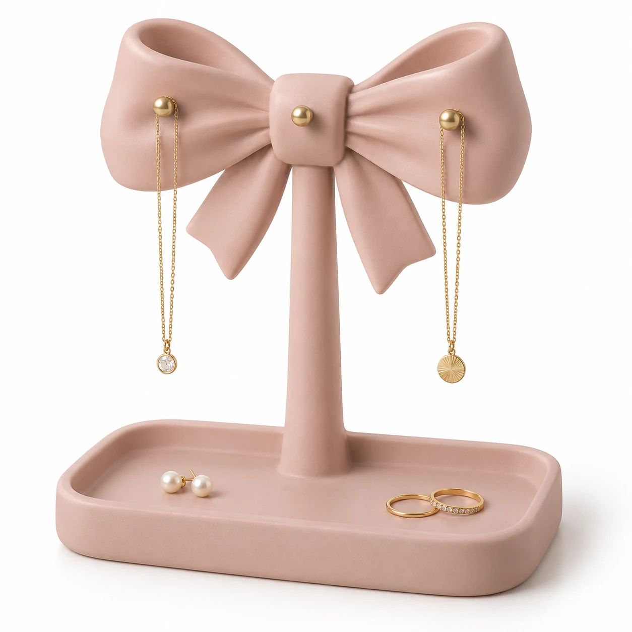 KELIKULI Ribbon Bow sculptural resin jewelry organizer with three gold-tone pegs and integrated vanity tray, styled with necklaces, pearl earrings and rings on a white background.
