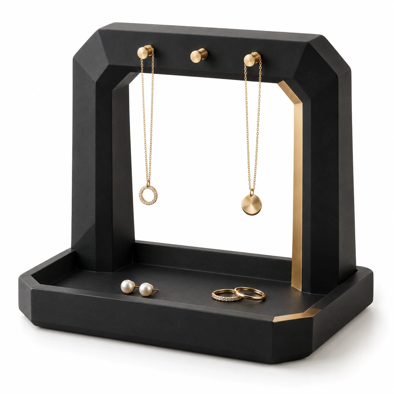 KELIKULI Black Gold Facet sculptural resin jewelry organizer with three gold-tone pegs and integrated vanity tray, styled with necklaces, pearl earrings and rings on a white background.